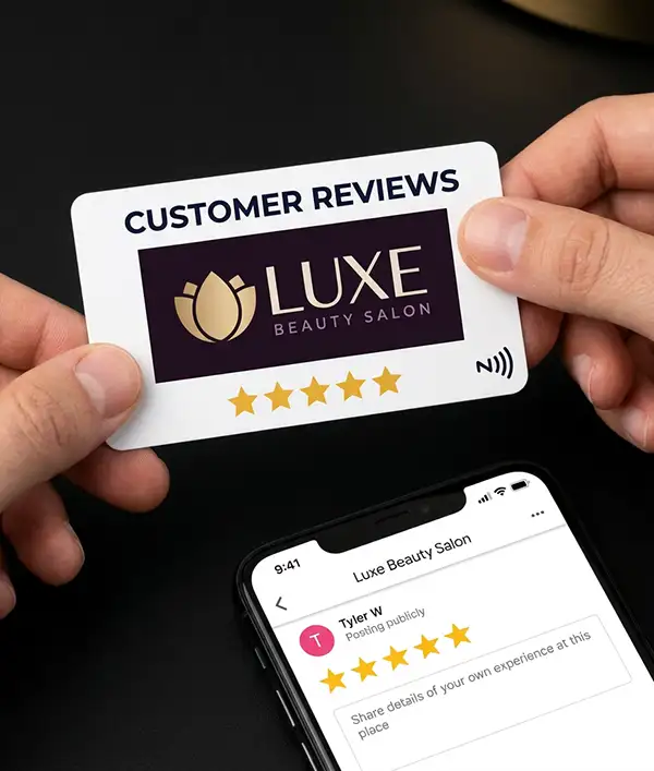 ReviewsNH NFC tap card being held near a phone showing a Google review form with 5 stars